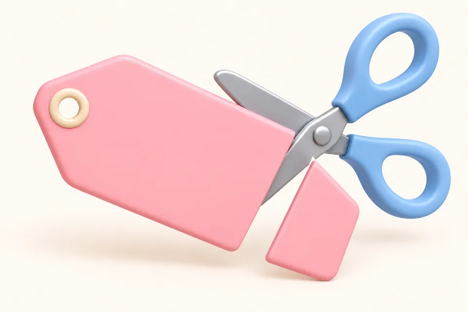 A pink price tag being cut by a pair of blue scissors. A small corner of the tag is falling away.